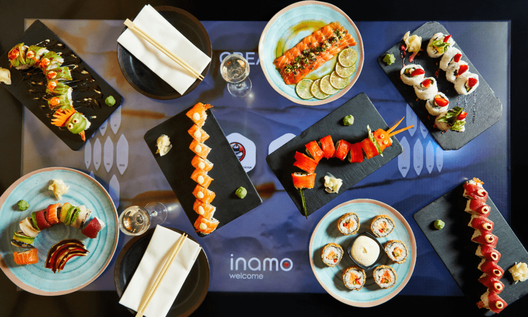 dishes on table - inamo welcome screen beneath